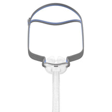 A nasal pillows mask with adjustable elastic headgear and a transparent frame.