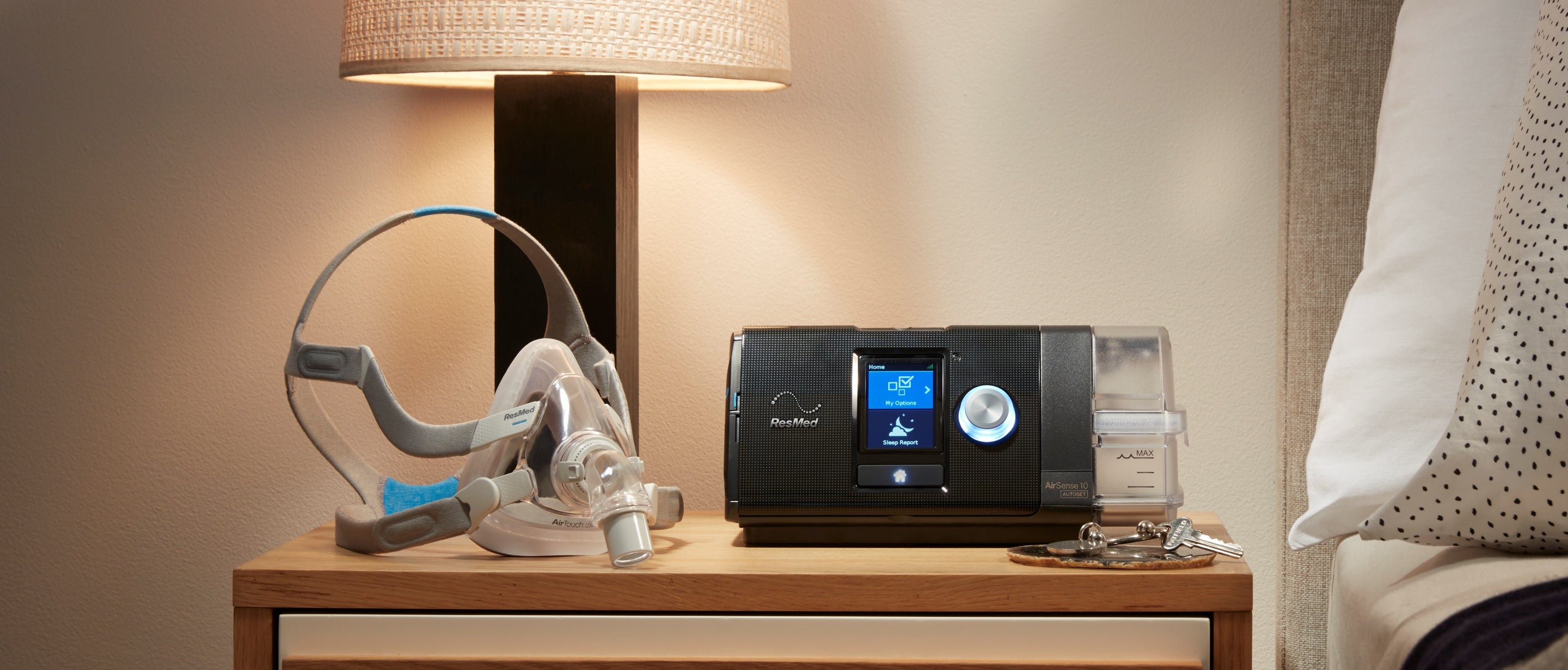 Bedside table with a ResMed AirFit F20 CPAP Mask and ResMed AirSense 10 AutoSet CPAP Machine on top