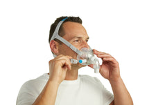 Man adjusting ResMed AirFit F30 Full Face Mask