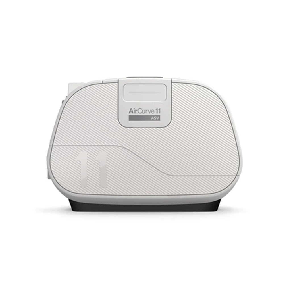 ResMed AirCurve 11 ASV device placed on top of a packed travel suitcase, representing portability for use while travelling.
