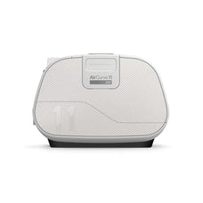 ResMed AirCurve 11 ASV device placed on top of a packed travel suitcase, representing portability for use while travelling.
