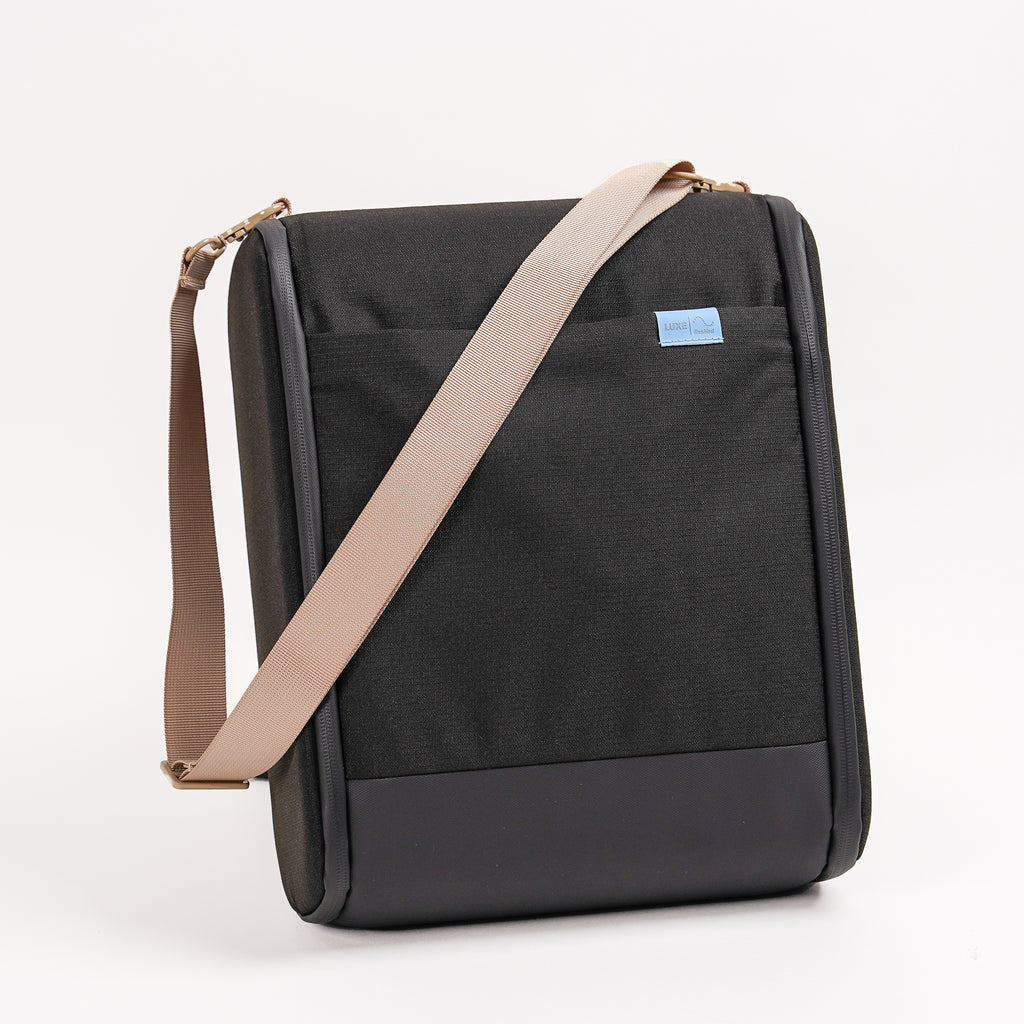 CPAP insert in black with beige straps draped ontop