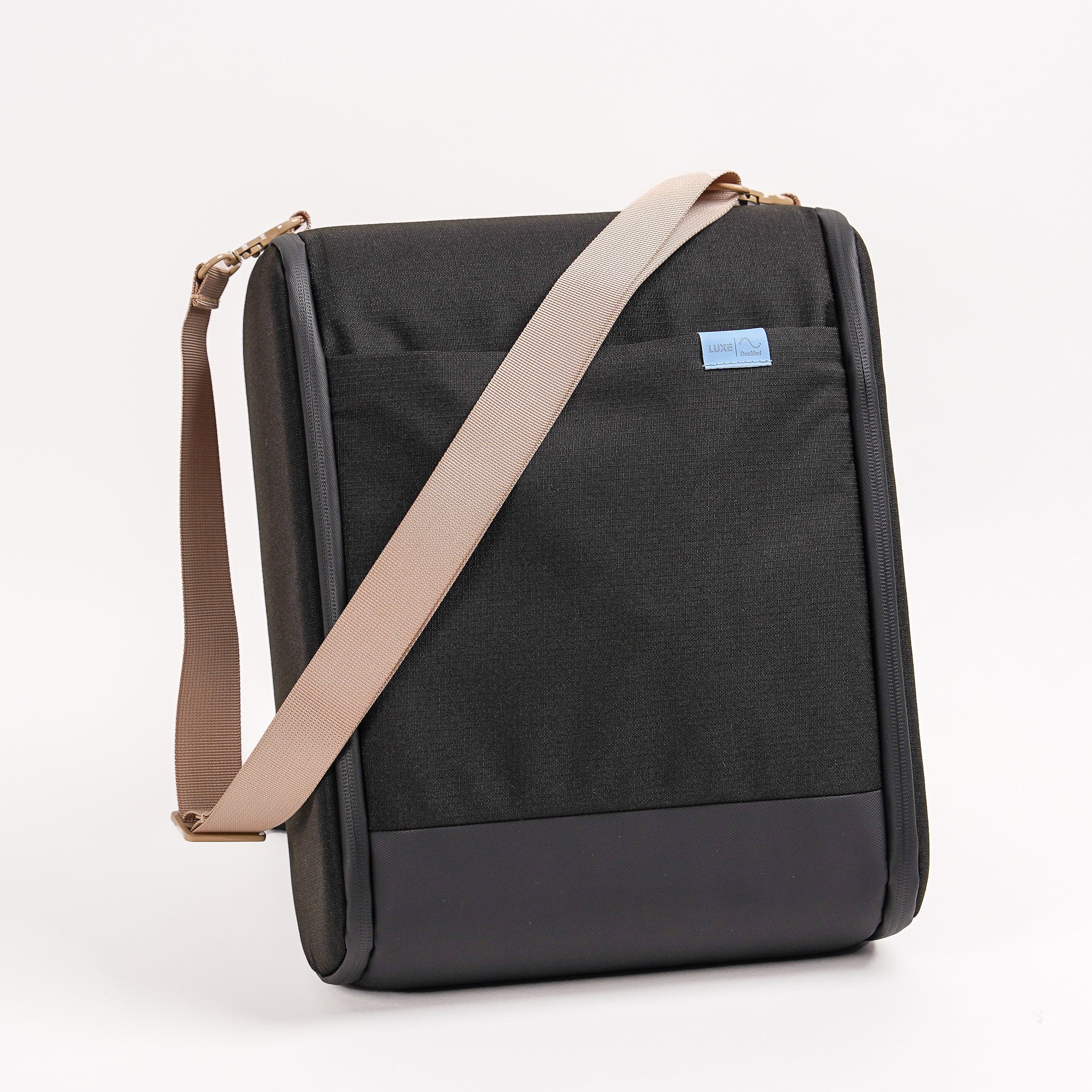 CPAP insert in black with beige straps draped ontop