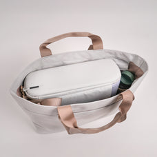 An open CPAP Tote that has a CPAP insert, a green waterbottle on the side compartment