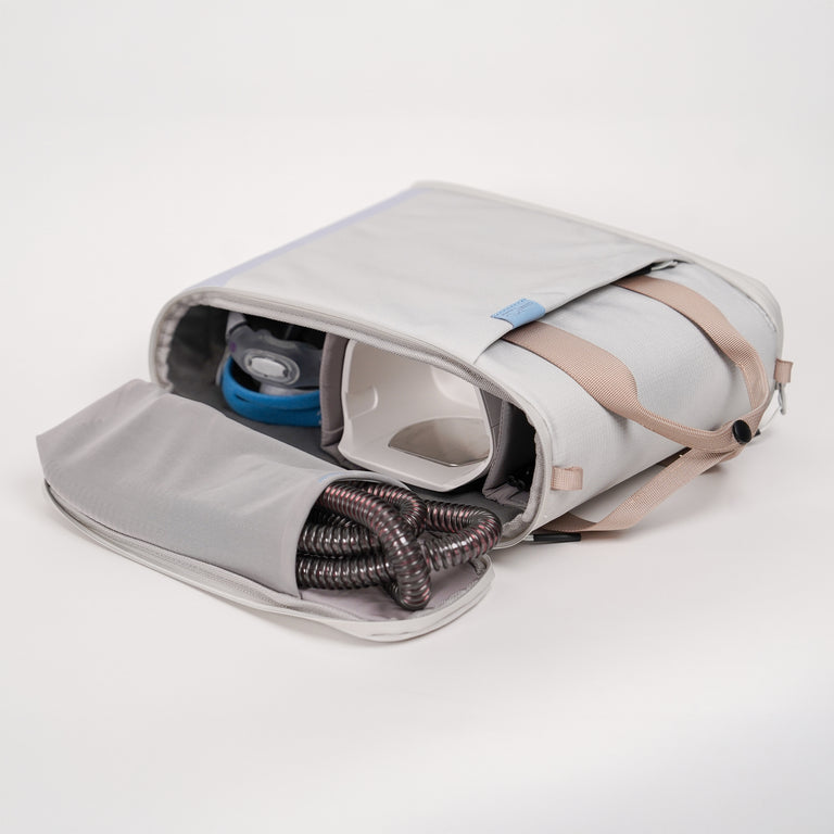 and open CPAP insert, inside there is a CPAP Mask and CPAP Machine, the tubing is on the lid