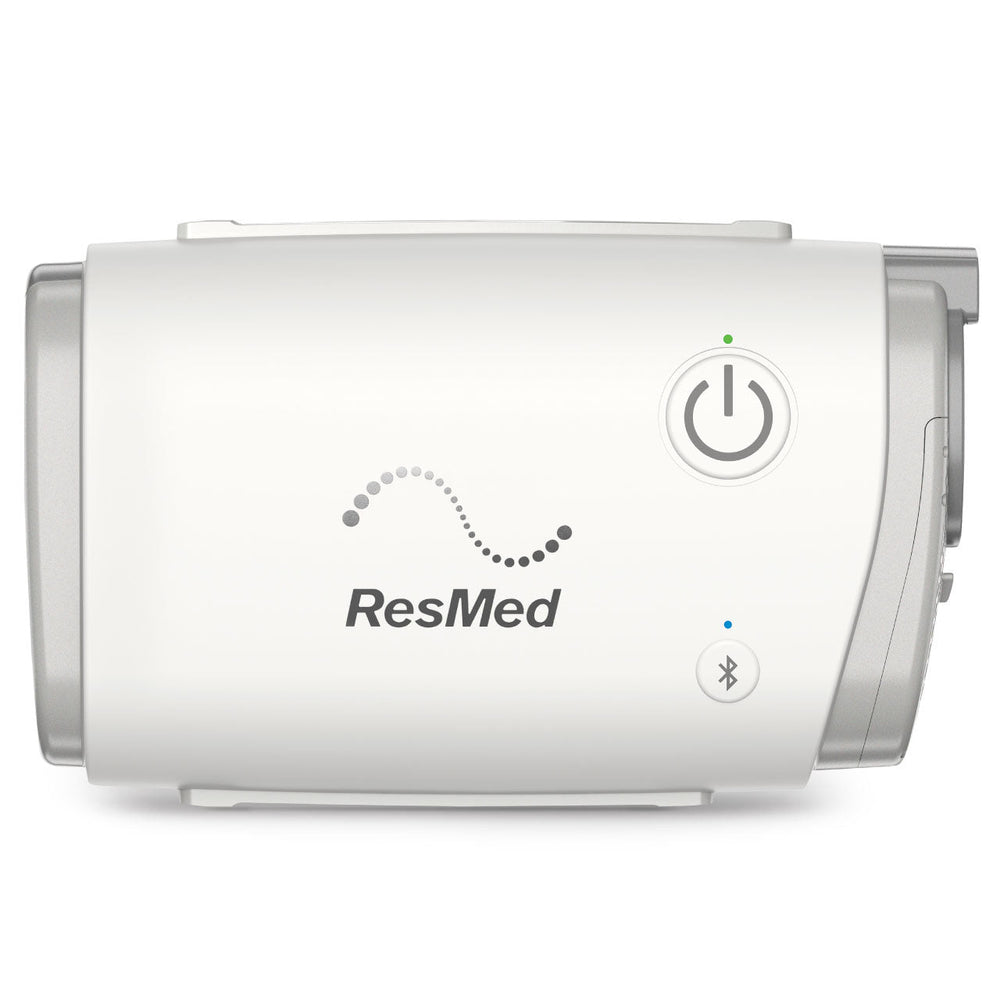 ResMed AirMini compact CPAP machine, front view showing power button and Bluetooth connectivity.