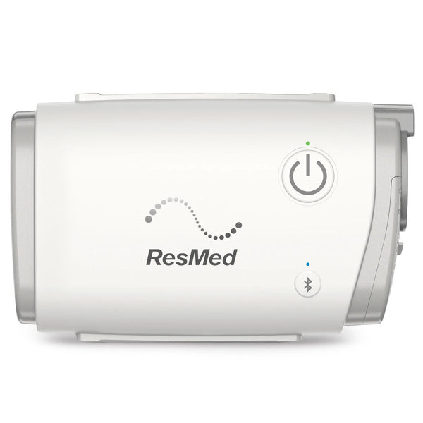 ResMed AirMini compact CPAP machine, front view showing power button and Bluetooth connectivity.
