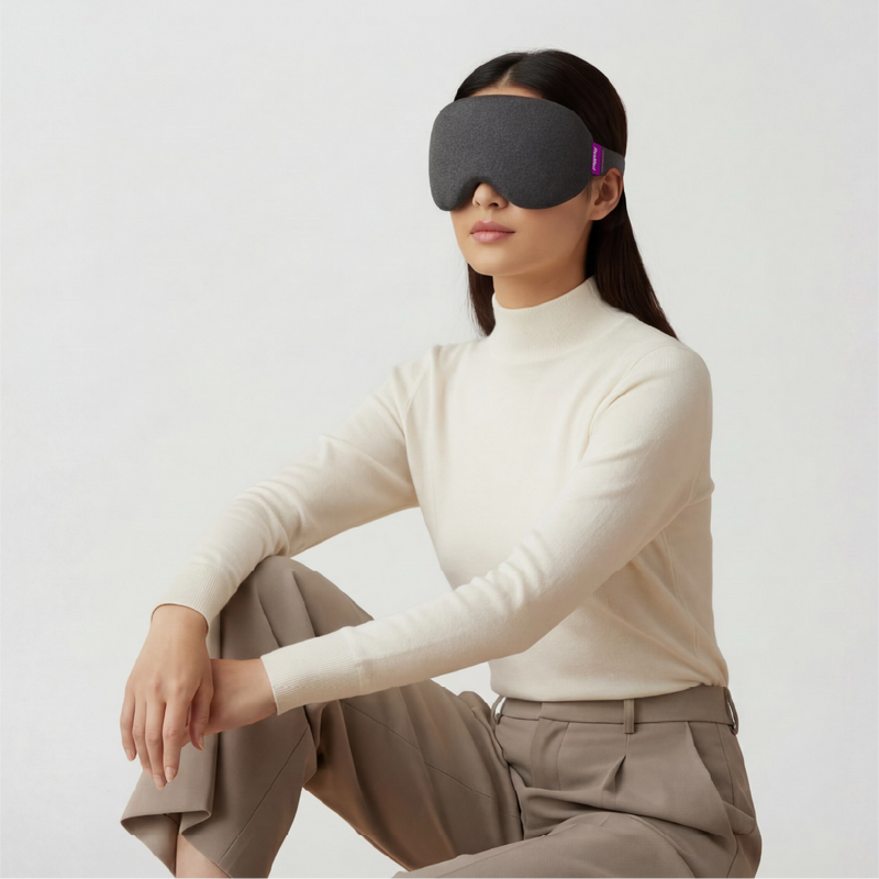 Woman wearing a white turtleneck and the nyx mask in charcoal grey