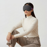 Woman wearing a white turtleneck and the nyx mask in charcoal grey