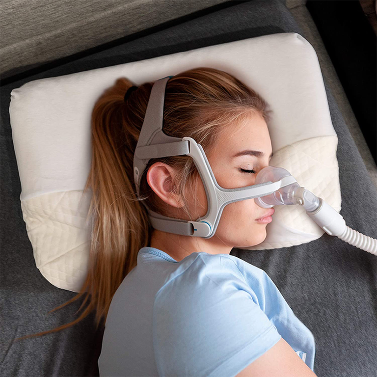 Person using CPAP Pillow with Mask